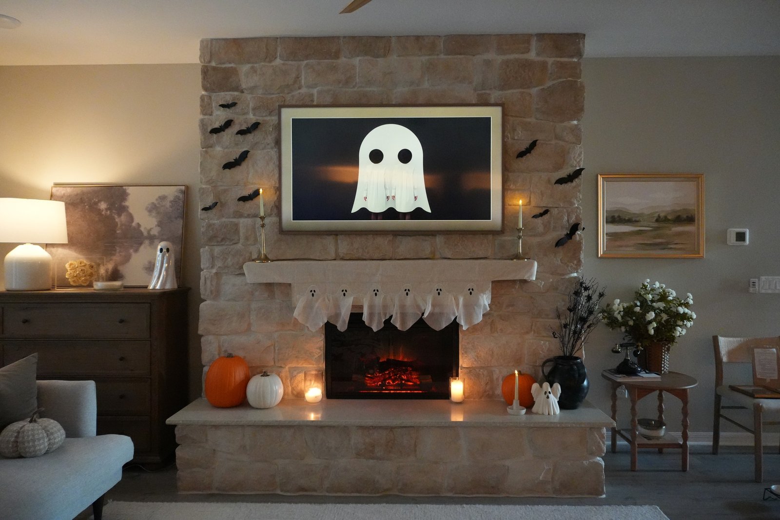 Finished stone fireplace with warm lighting and seasonal decor